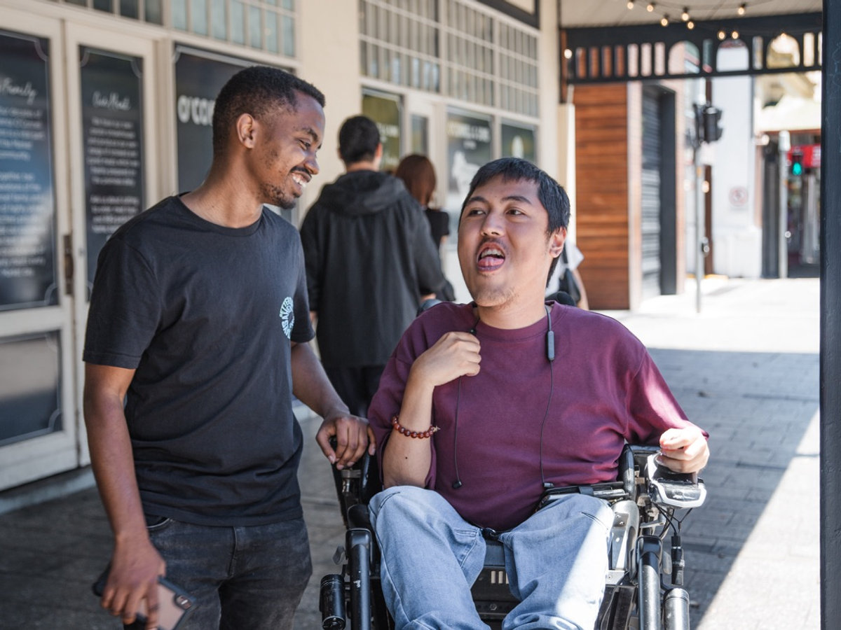 A support worker taking a participant out into the community